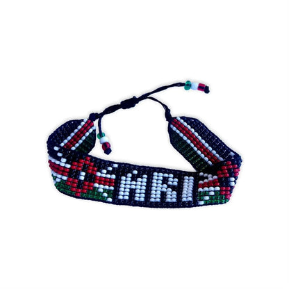 Side view of a beaded bracelet showcasing a mix of red, green, white, and black beads with a geometric pattern.